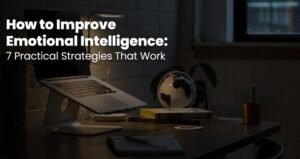 Quiet desk with a laptop, lamp and books at night, a calm space to improve emotional intelligence