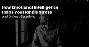 Thoughtful man looking out of a window in a dark room, using emotional intelligence to handle stress