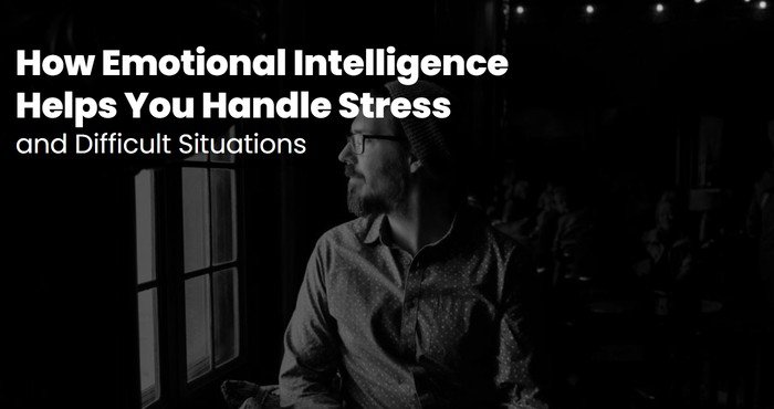 Thoughtful man looking out of a window in a dark room, using emotional intelligence to handle stress